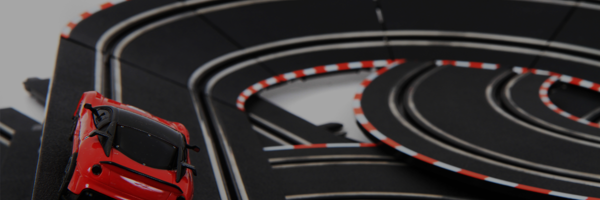 Model car on a track with red and white detailing