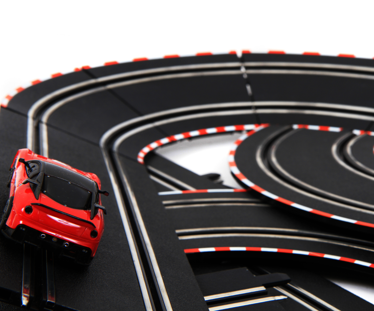 Red toy car on a black and red track with loops