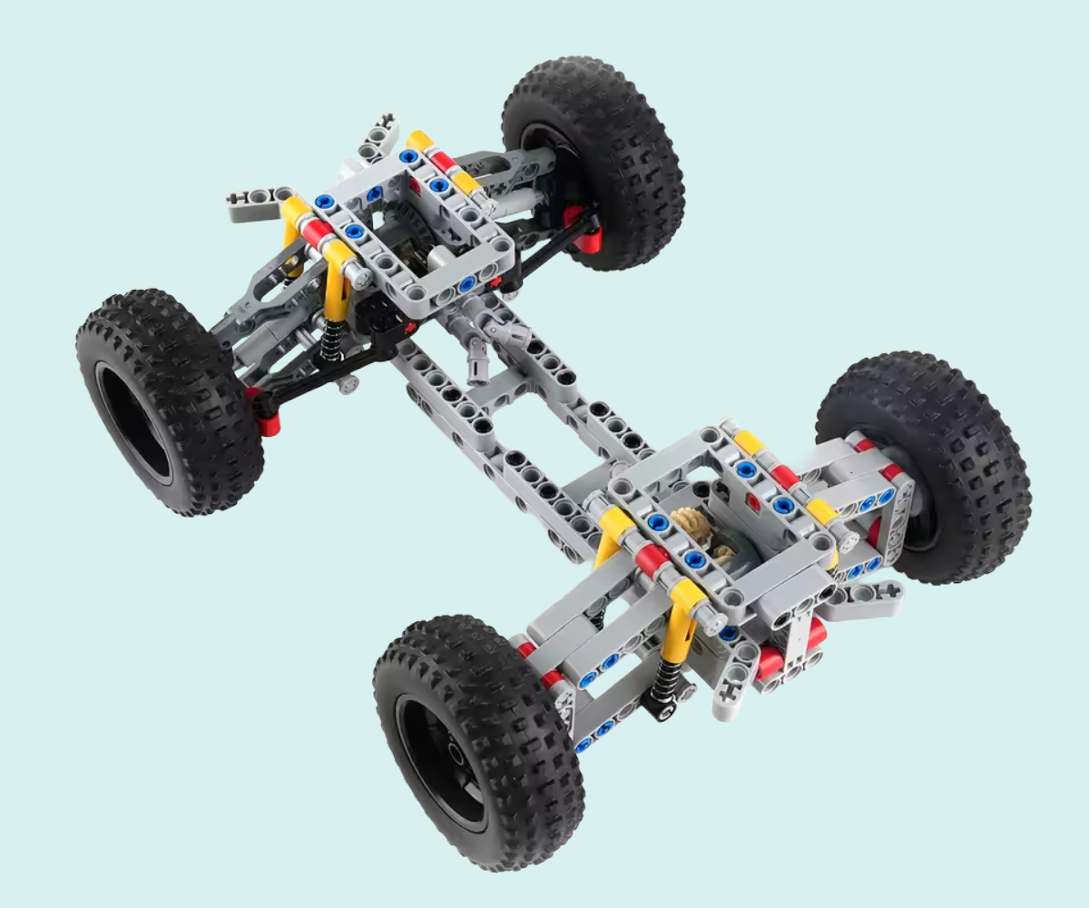 Toy car chassis with wheels on a light blue background