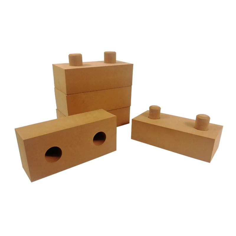 Set of wooden blocks with cylindrical and circular holes on a white background