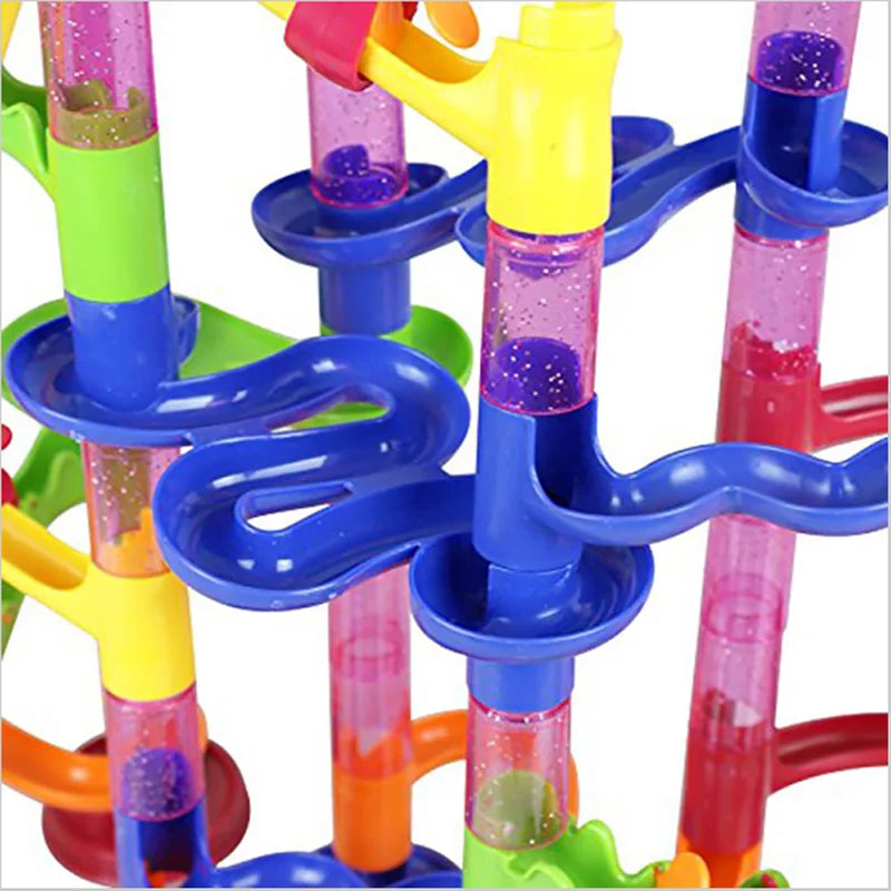 Colorful marble run toy with interlocking tubes on a white background