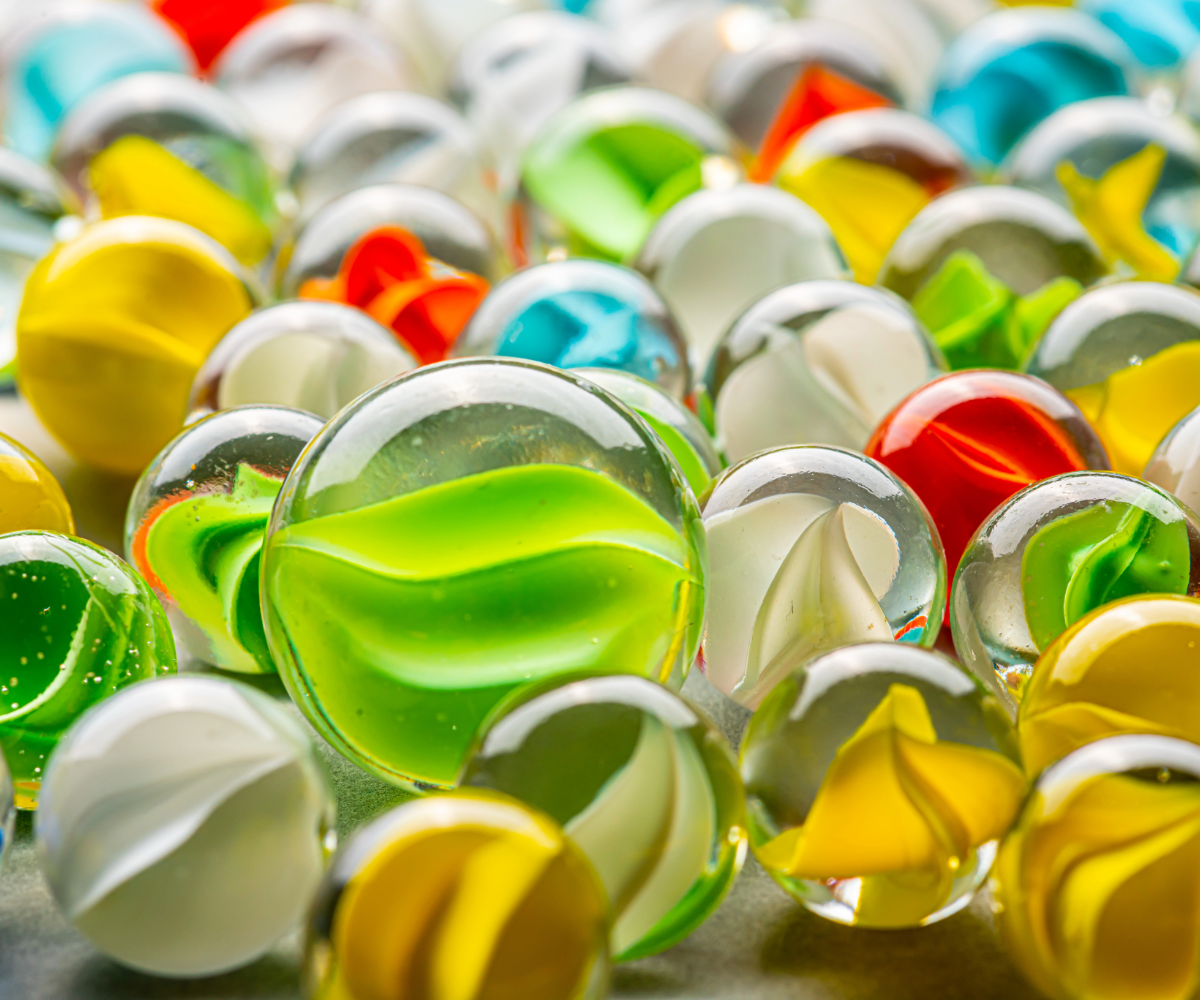 Colorful glass marbles with a green marble in the center.