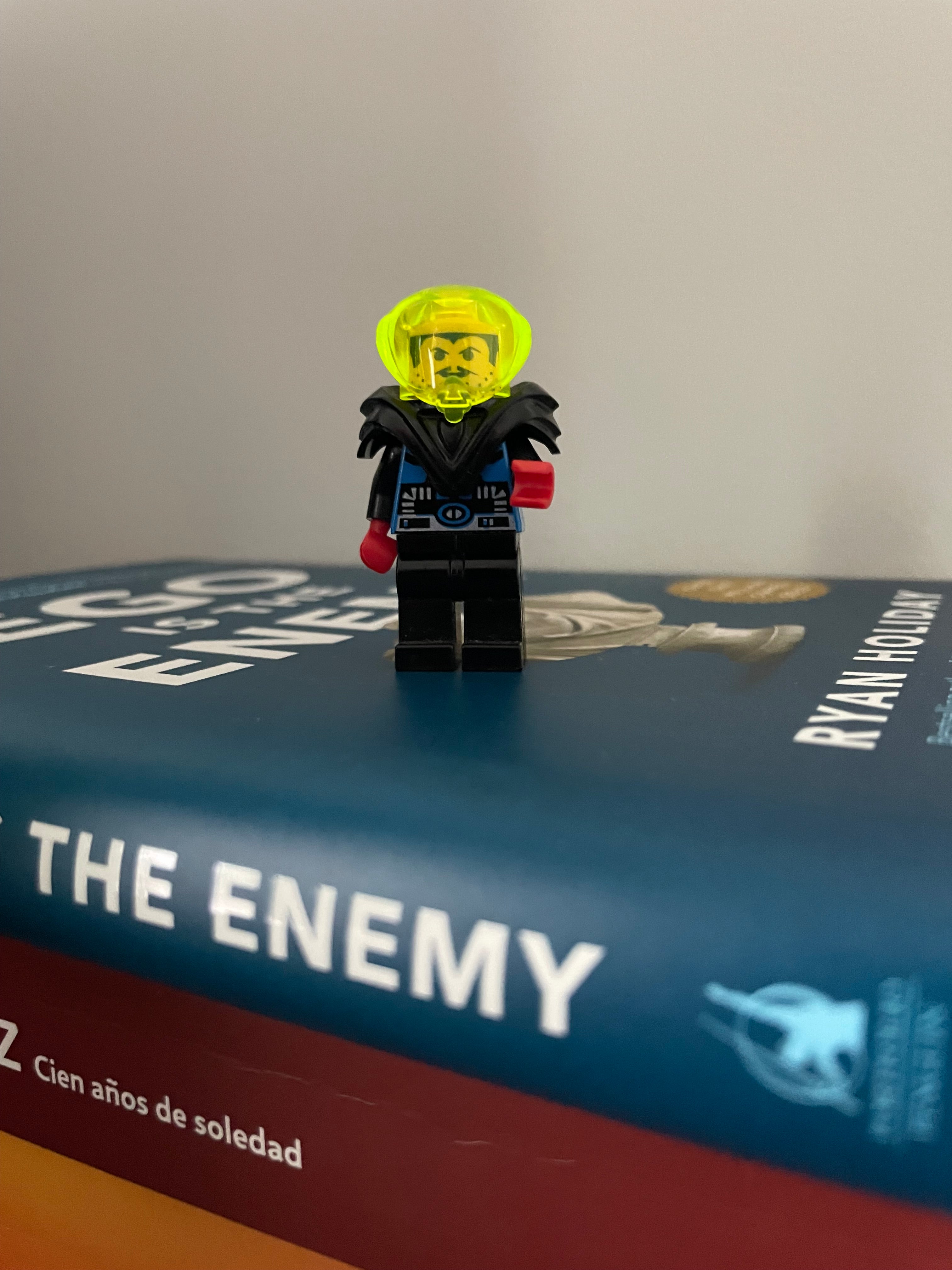 Toy figure on a book titled 'The Enemy' by Ryan Higa