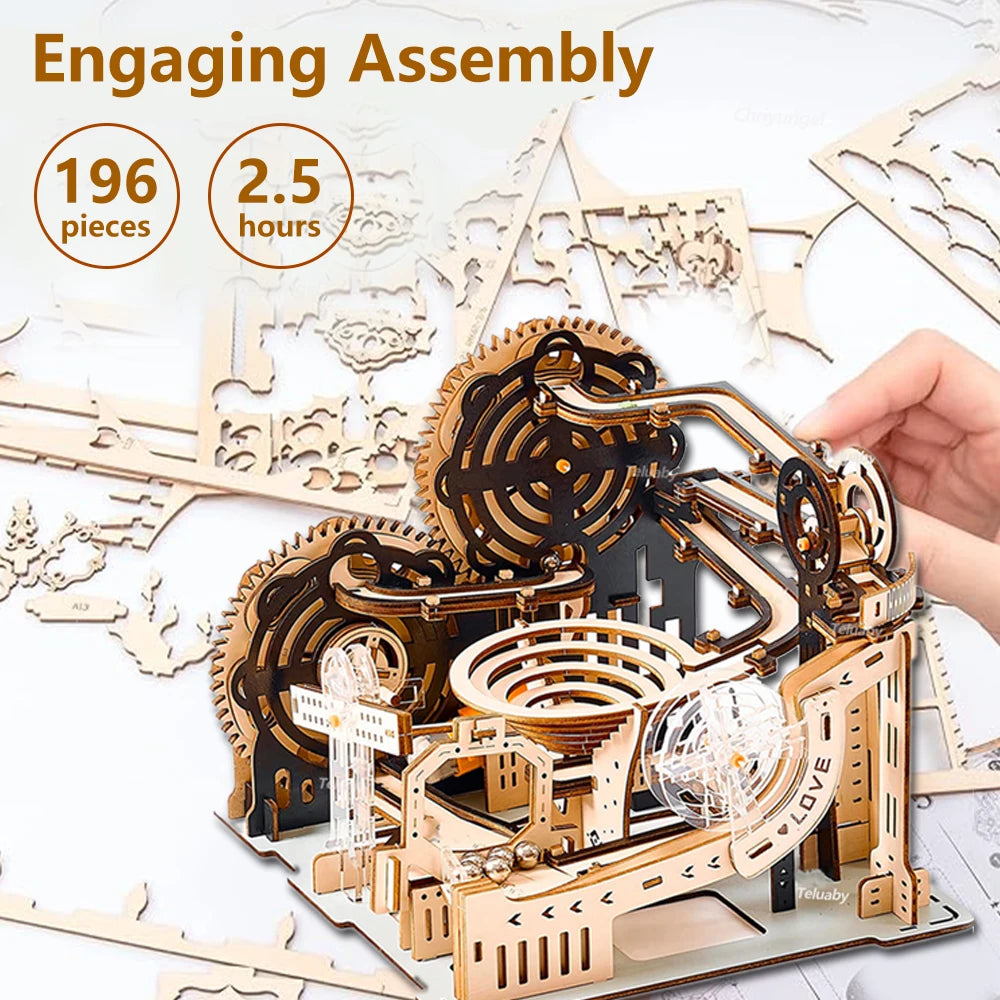 Wooden mechanical model kit with assembly instructions and a hand holding a completed section.