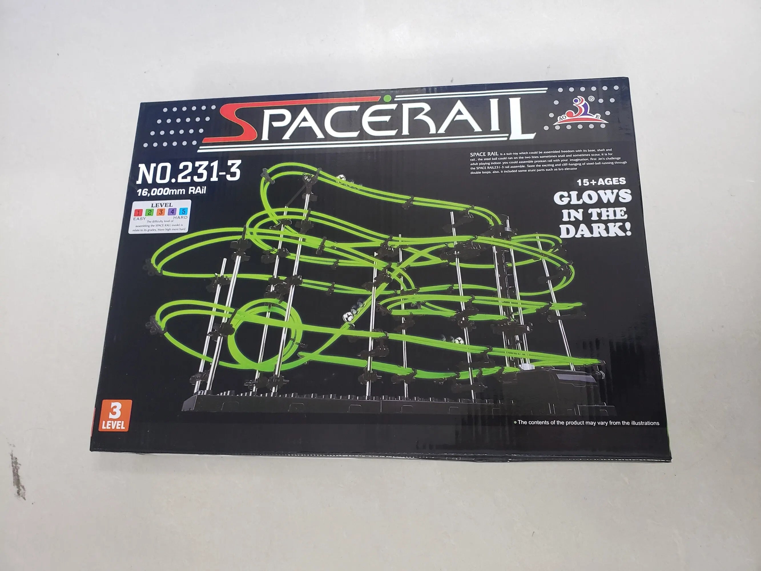 SpaceRail toy set packaging with green tracks on a black background