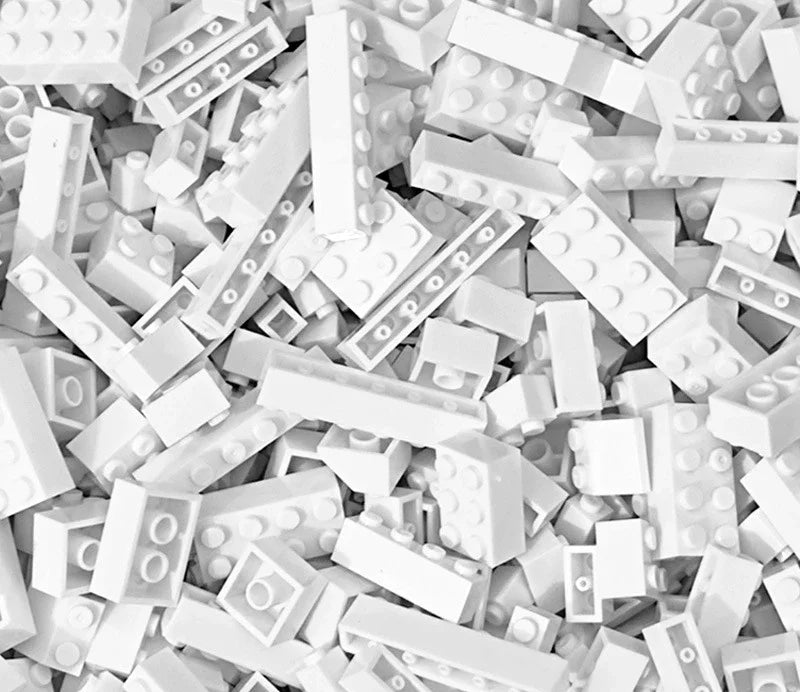White building blocks scattered on a white background