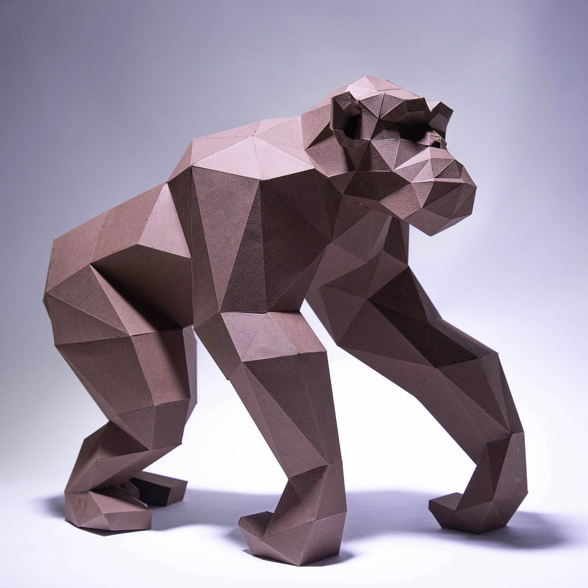 Geometric brown bear sculpture on a white background