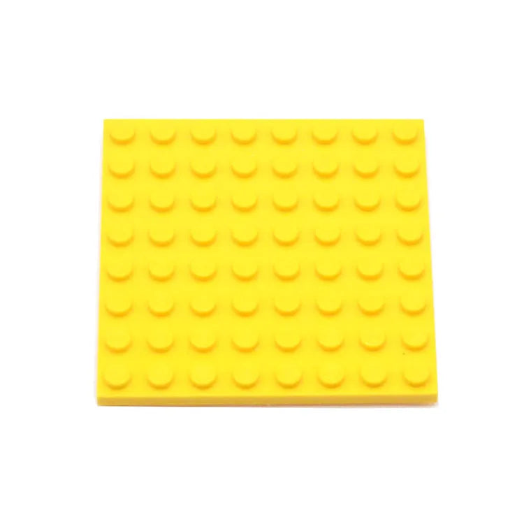 Yellow building block baseplate on a white background