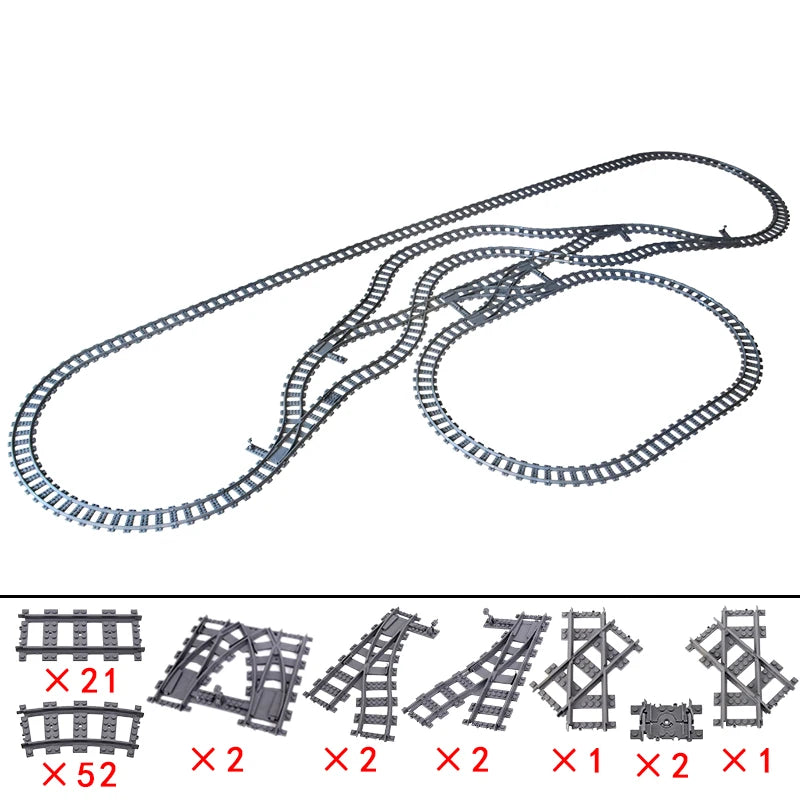 Model train track set with various pieces on a white background