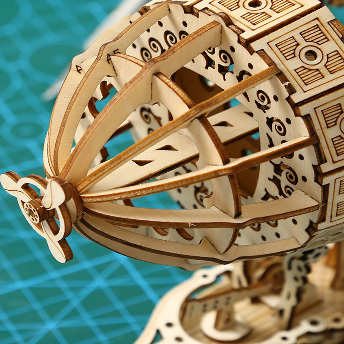 Wooden mechanical model on a blue grid background