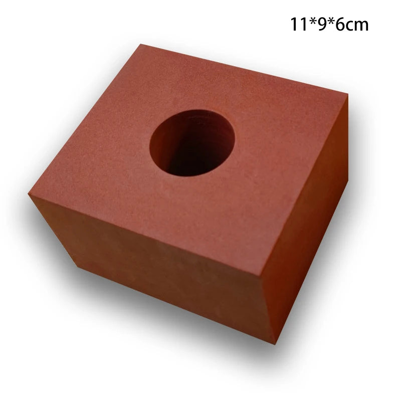 Red square block with a circular hole on a white background