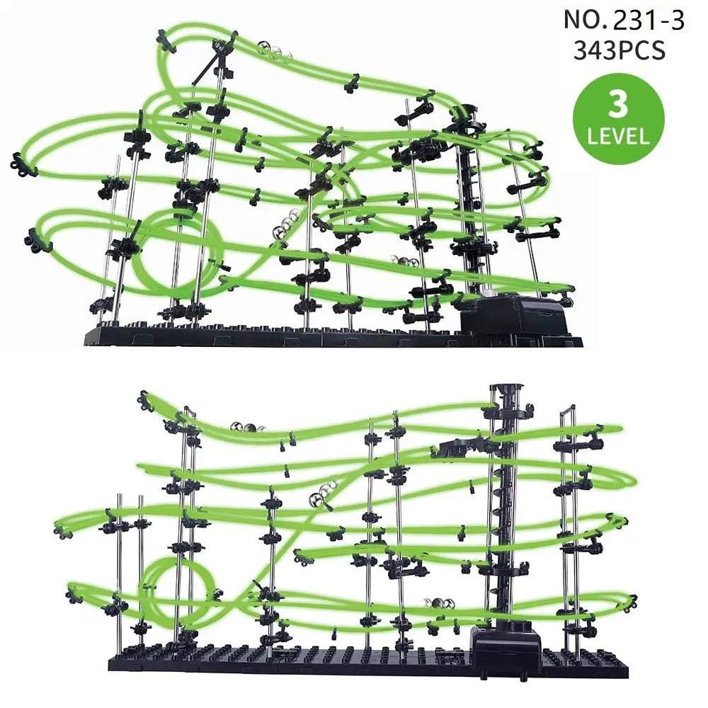 Toy marble roller coaster set with green tracks and black supports on a white background