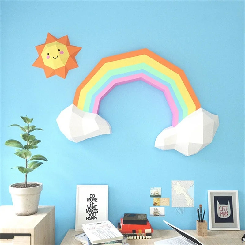 Decorative wall stickers of a sun, rainbow, and clouds on a blue wall above a desk.