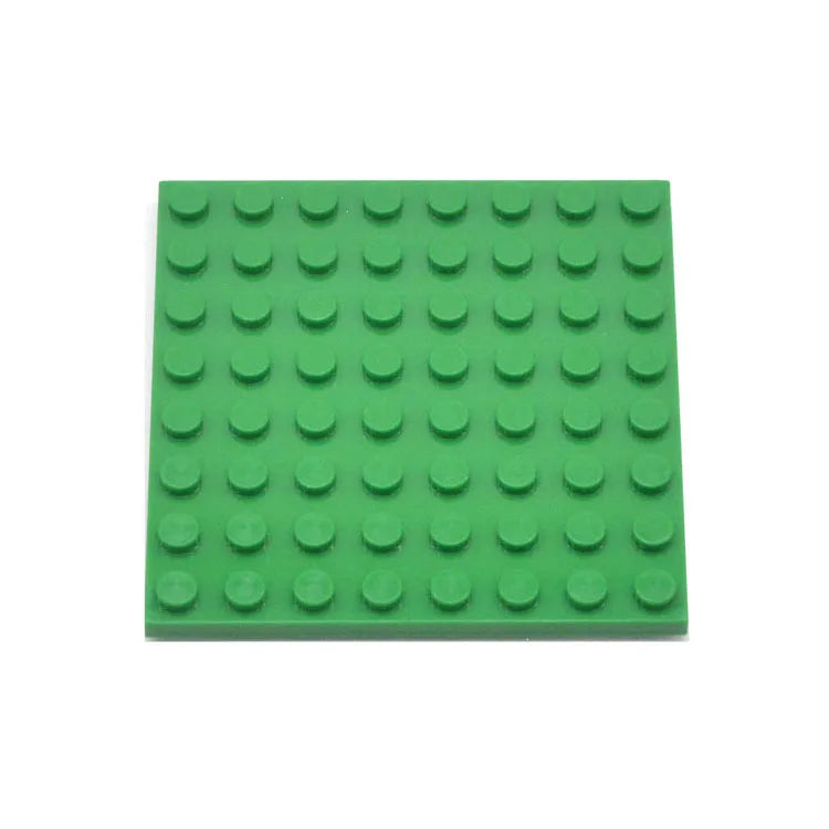 Green building block baseplate on a white background