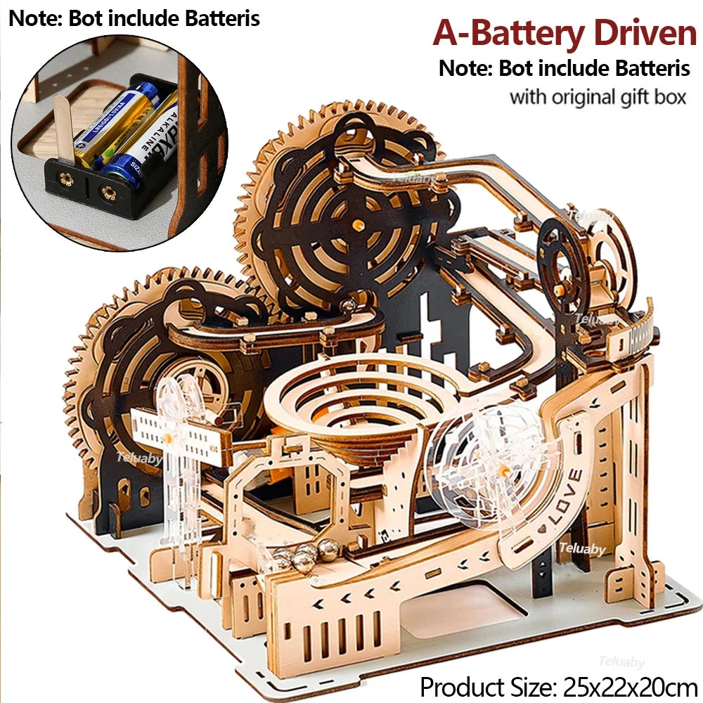 Wooden mechanical model with gears and a ball, including batteries and gift box on a white background.