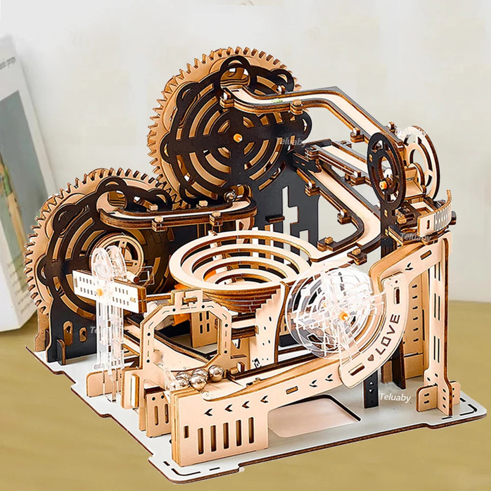 Wooden mechanical model kit with gears and clear components on a white background