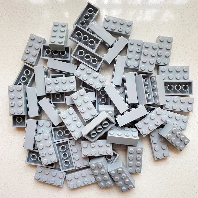 Pile of gray building blocks on a light surface
