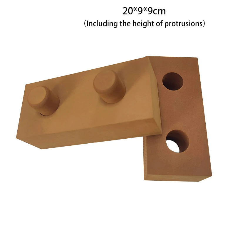 Brown building block piece with two cylindrical protrusions on a white background
