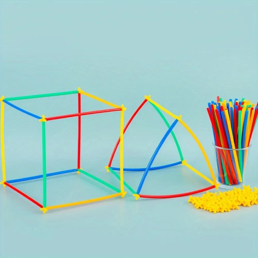 Colorful geometric shapes made from interlocking sticks and a glass container with more sticks on a light blue background