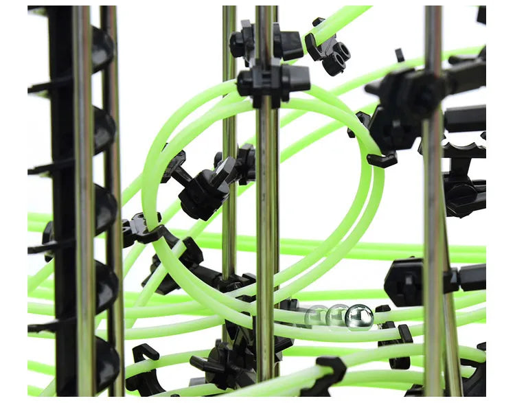 Close-up of a mechanical structure with green tubes and black connectors on a white background