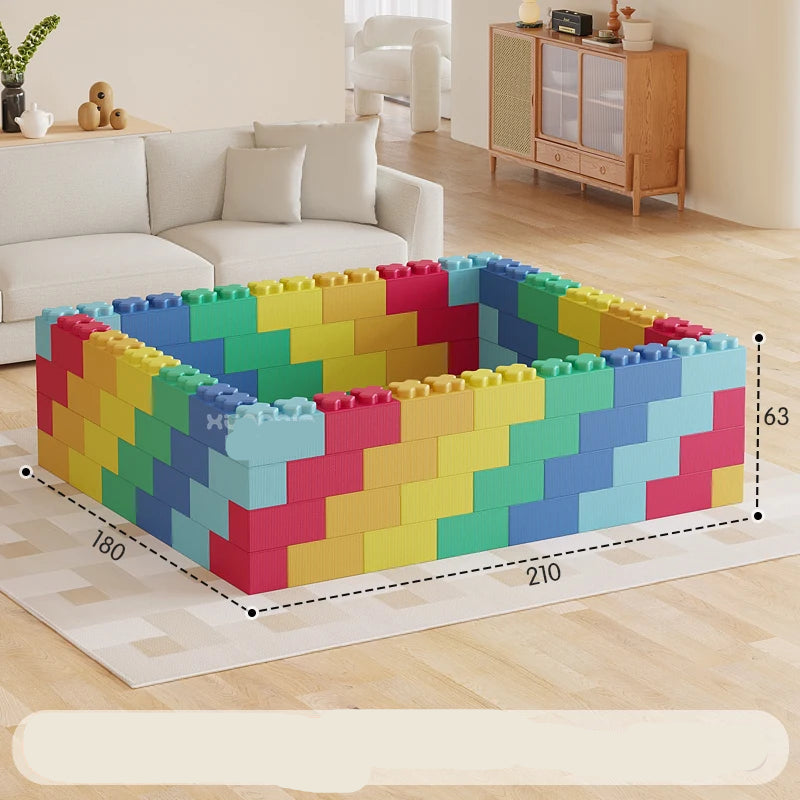 Colorful building block set on a wooden floor with a sofa and cabinet in the background