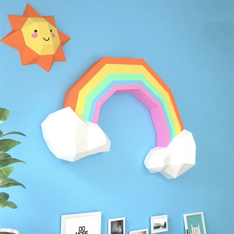 Colorful paper rainbow with sun and clouds on a blue wall
