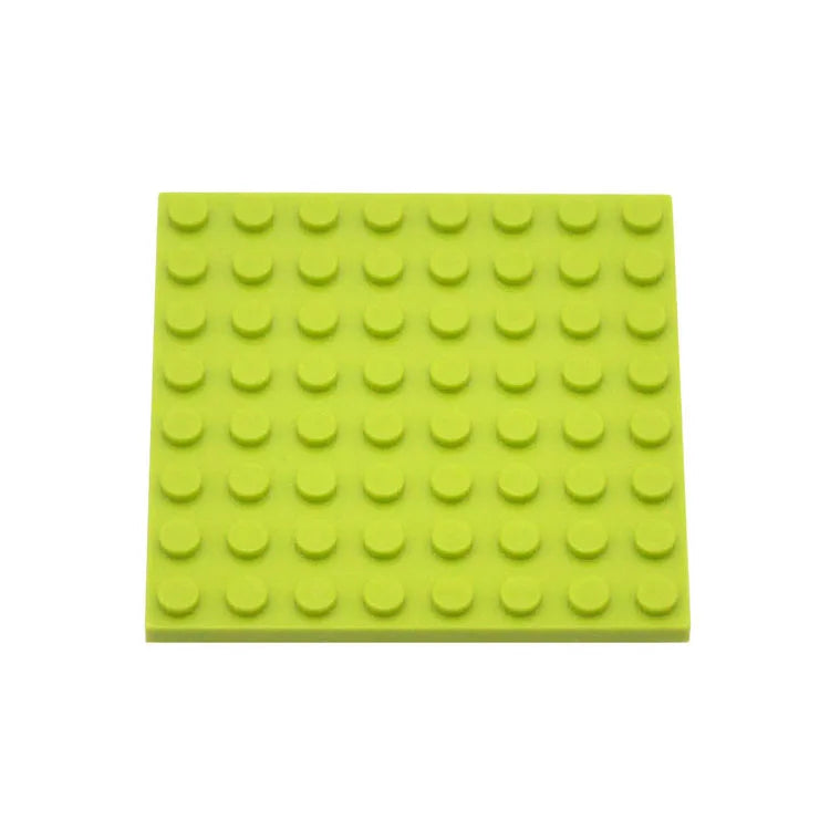 Green building block baseplate on a white background