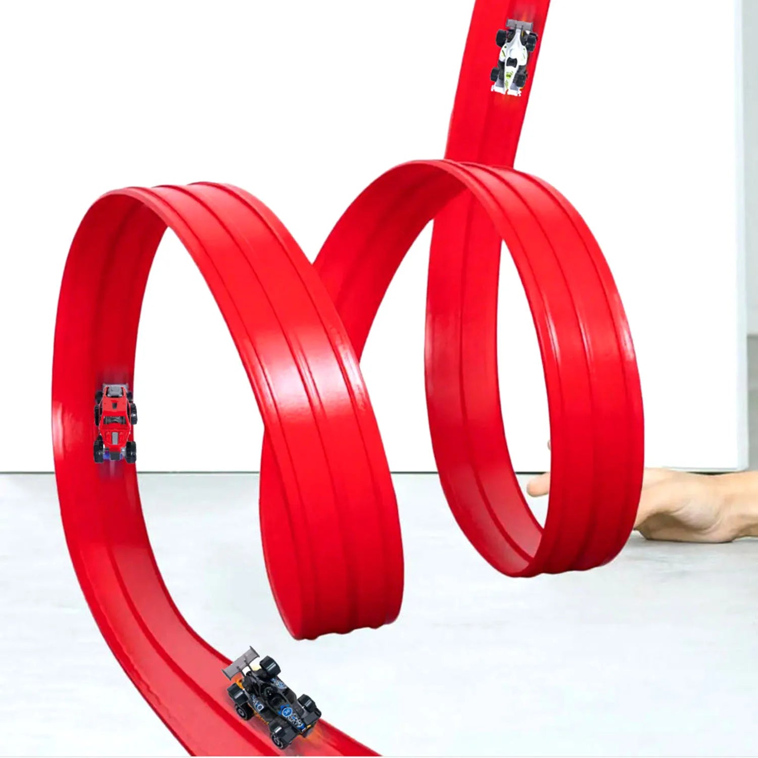 Red toy track with two cars on a white background