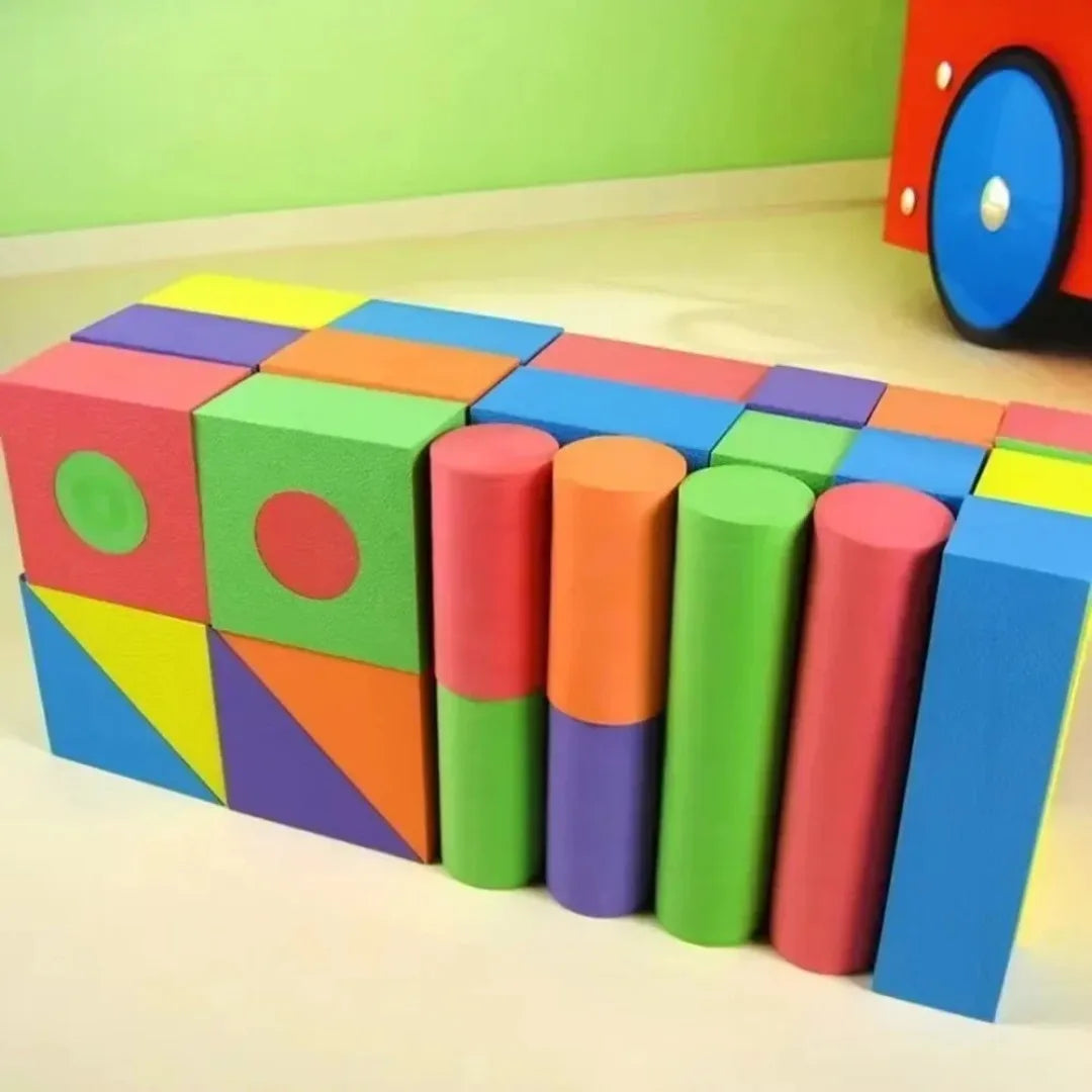 Colorful foam blocks on a wooden surface with a green wall background