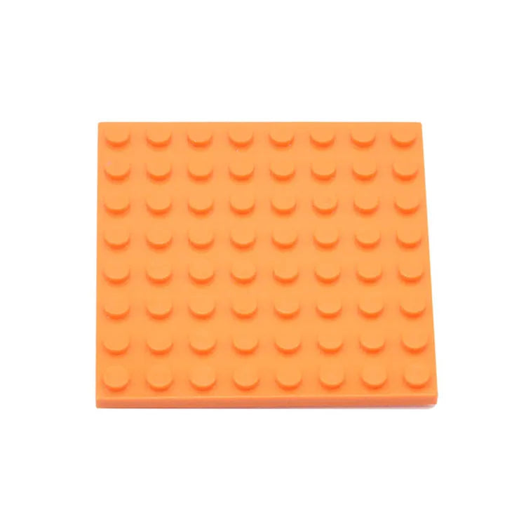 Orange building block baseplate on a white background