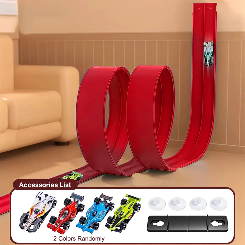 Red toy track set with accessories on a wooden floor.