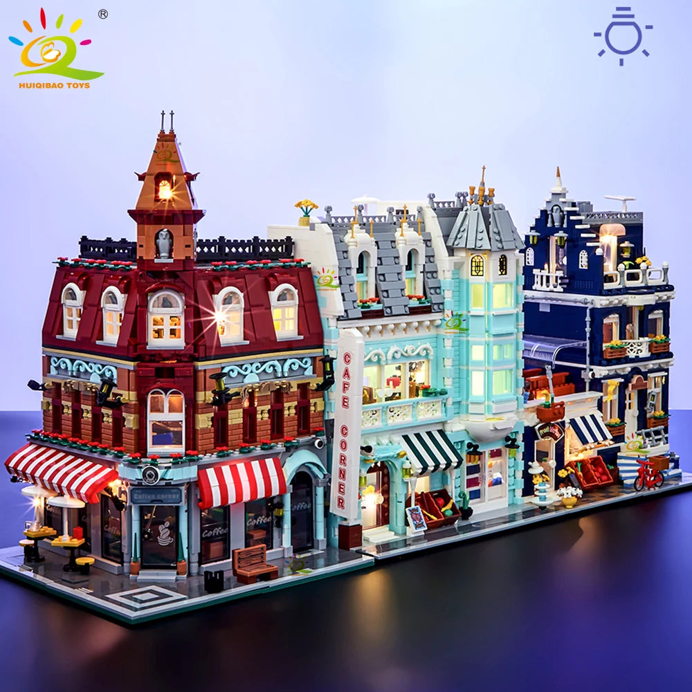 Model of a city street with buildings and shops, featuring colorful facades and street lights.