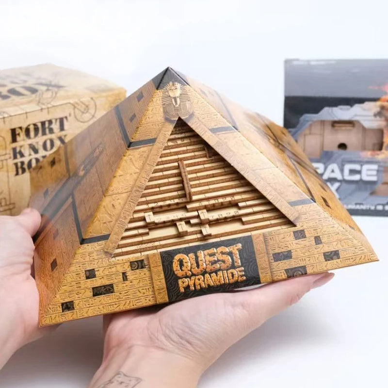 Wooden pyramid model with 'Quest Piramide' branding held by a person.