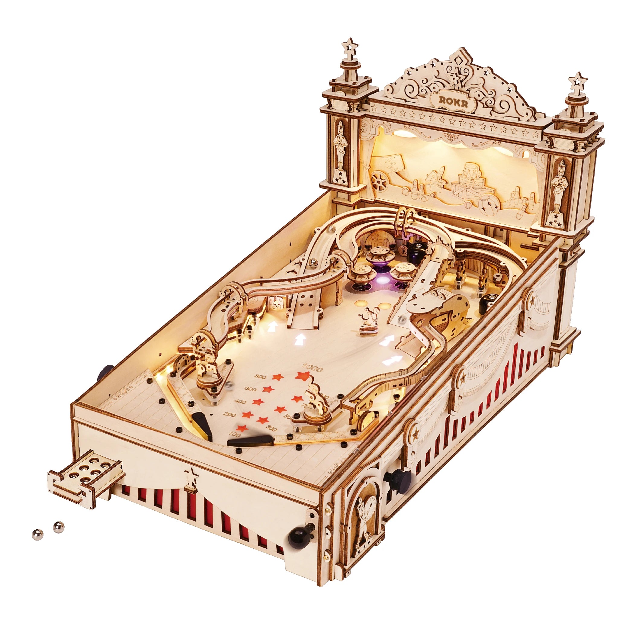 Wooden mechanical model of a pinball machine on a white background