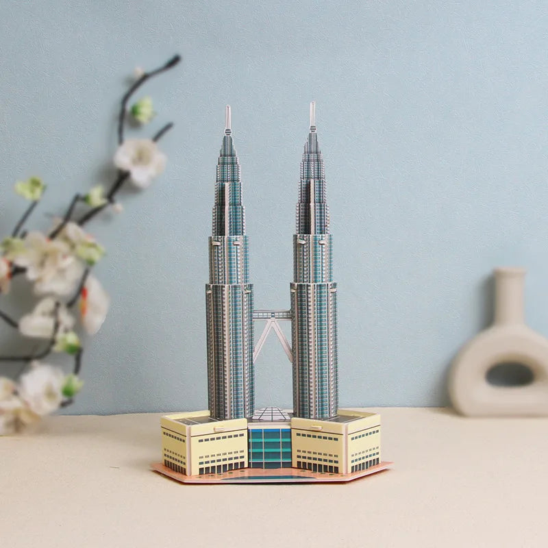 Model of Petronas Towers on a table with a light blue wall and decorative elements in the background
