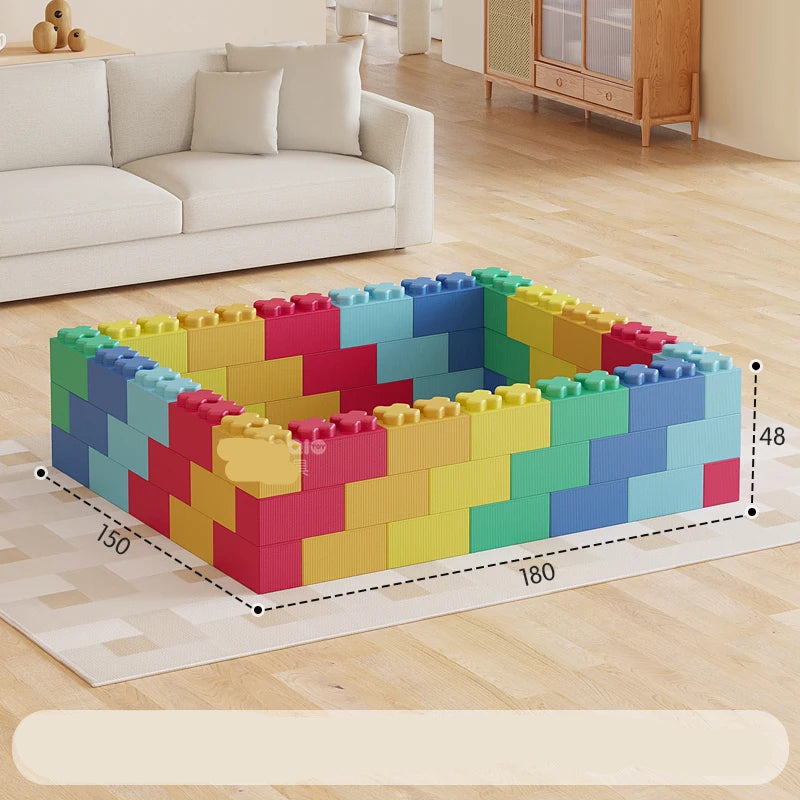 Colorful building blocks arranged in a geometric pattern on a wooden floor.