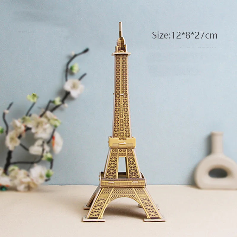 Model of the Eiffel Tower on a light blue background with decorative elements.