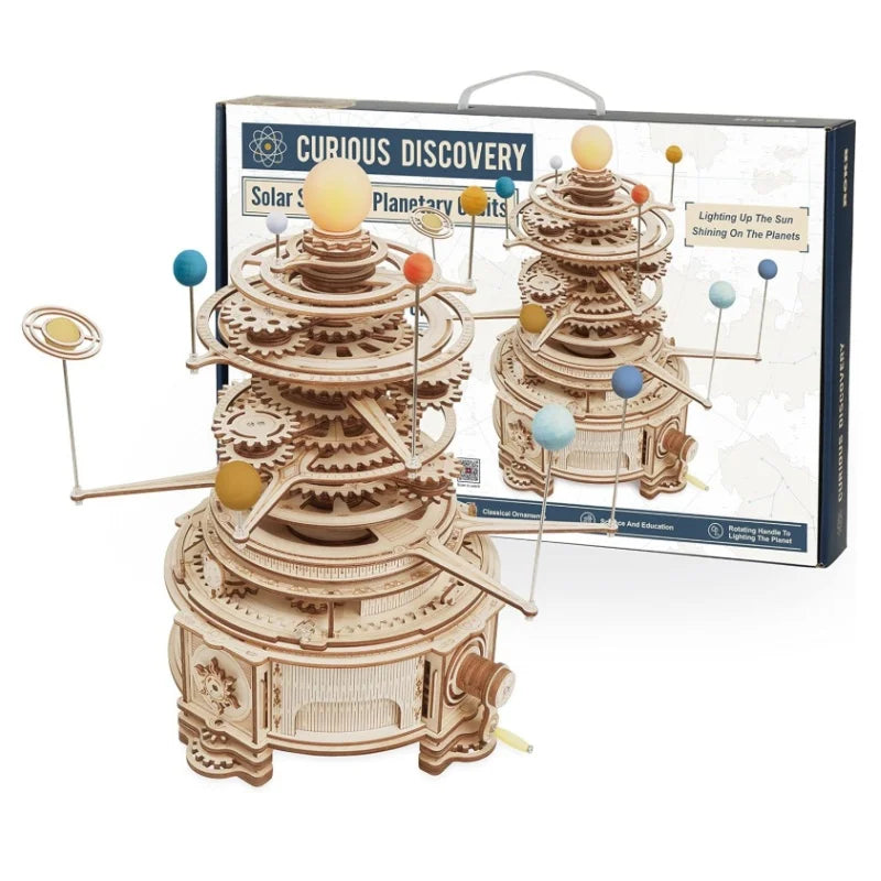 Wooden solar system model with packaging labeled 'Curious Discovery' on a white background