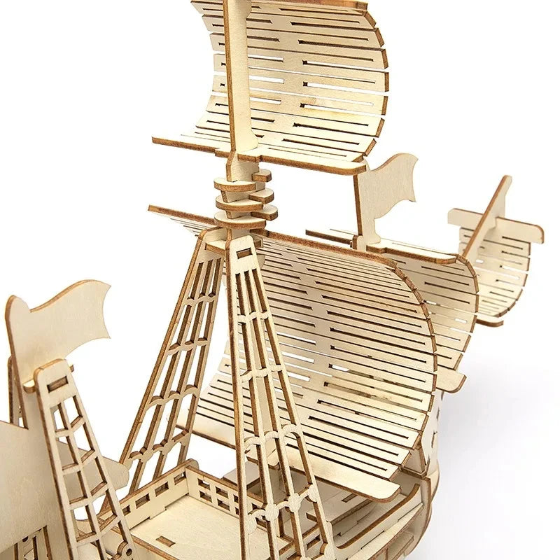 Wooden model of a windmill on a white background