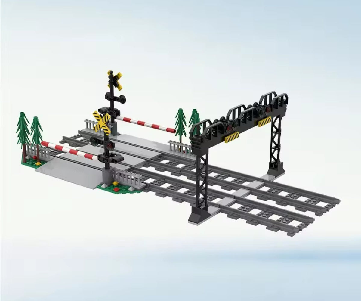 Model railway set with tracks, signal lights, and barriers on a light blue background