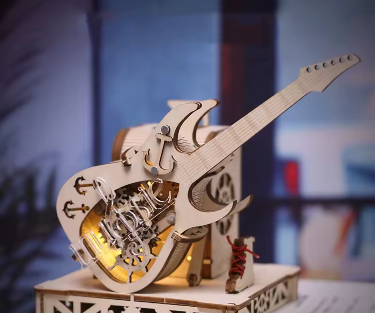 Wooden guitar model with mechanical details and LED light on a blurred background